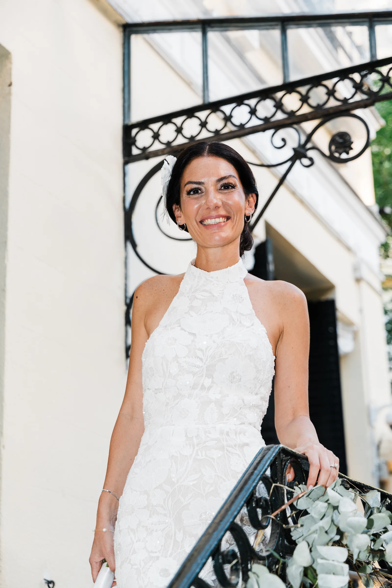 Portrait of a bride smiling on an iron staircase