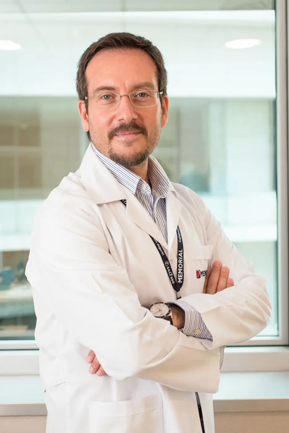 Clinician in a white coat photographed against a window