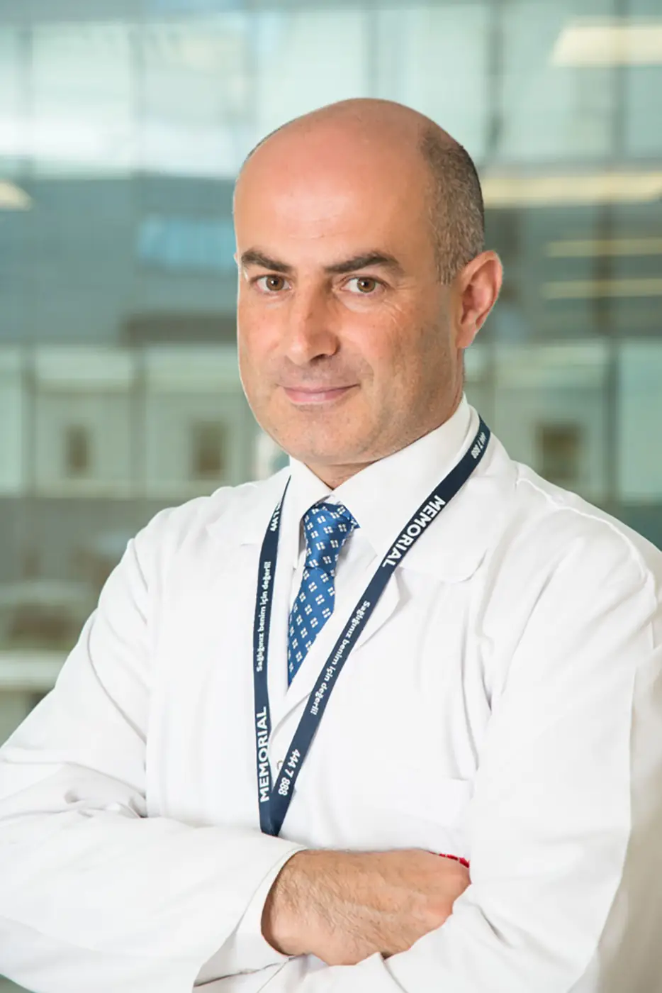 Clinician with a lanyard photographed against a window