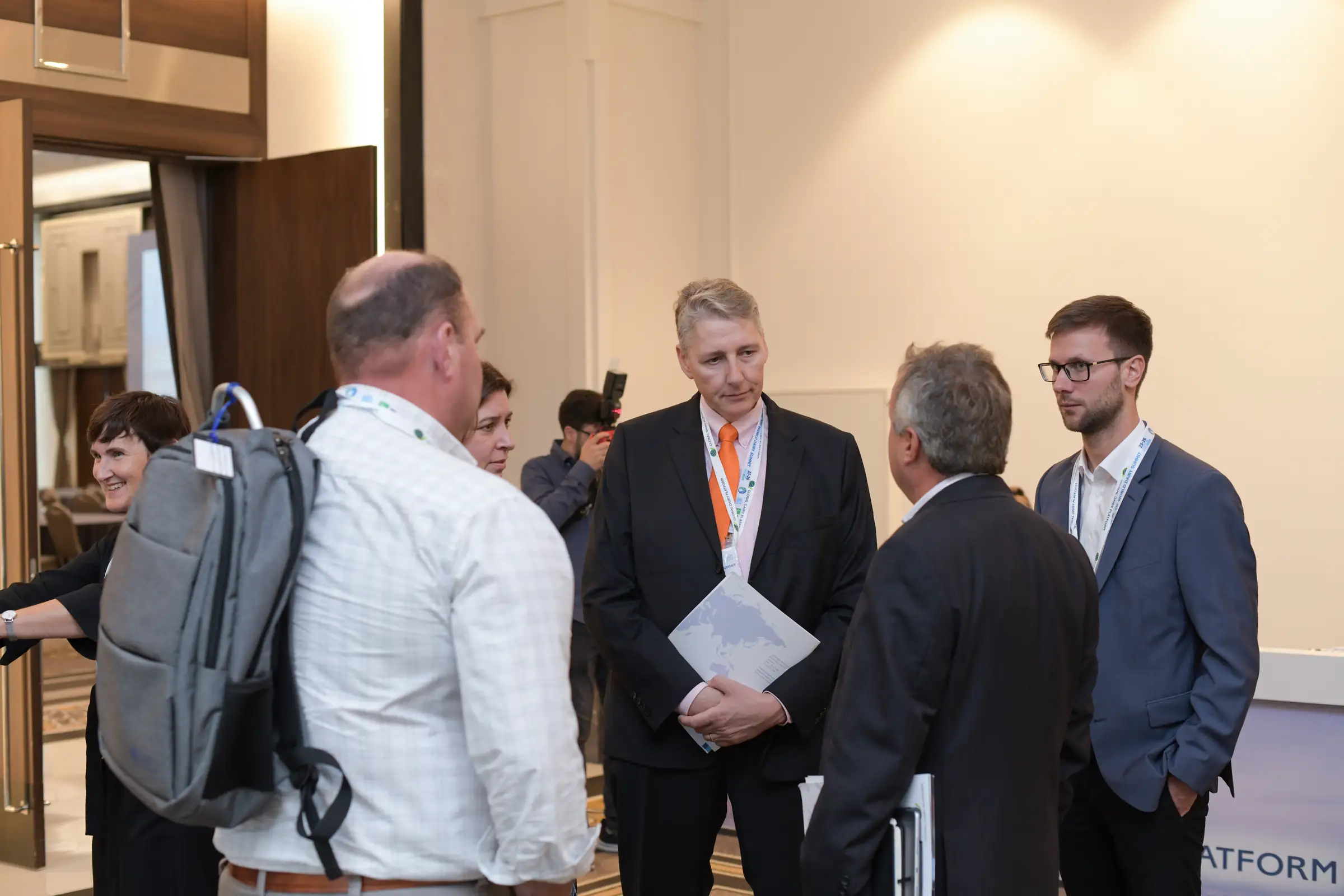 Delegates talking in small groups during a conference break