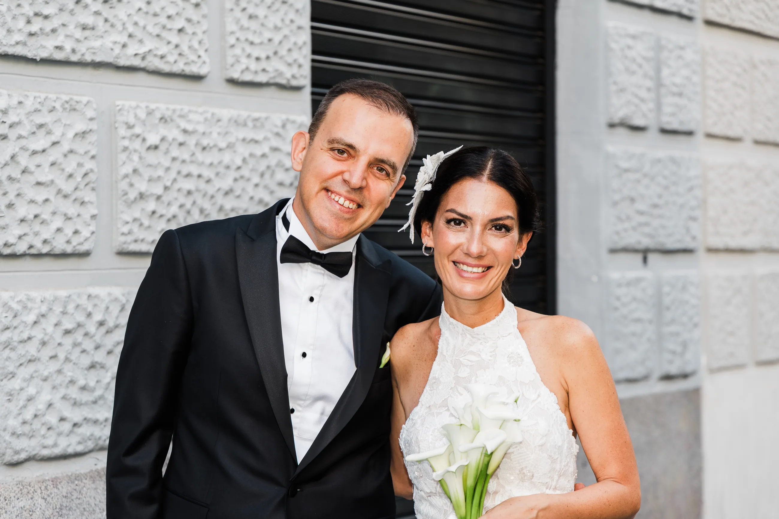 Close portrait of the bride and the groom smiling on a Madrid street