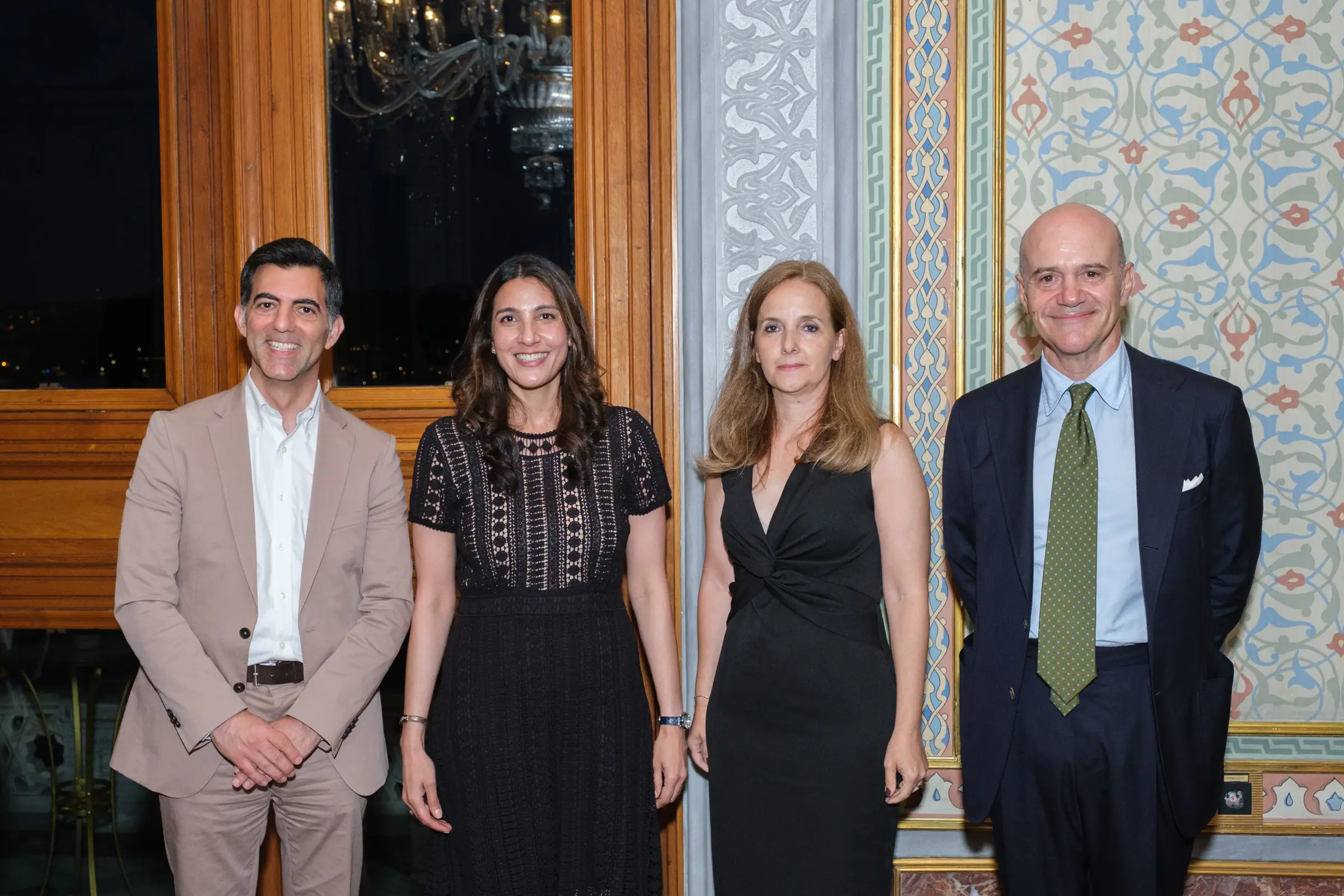 Group portrait of four guests at an evening corporate event