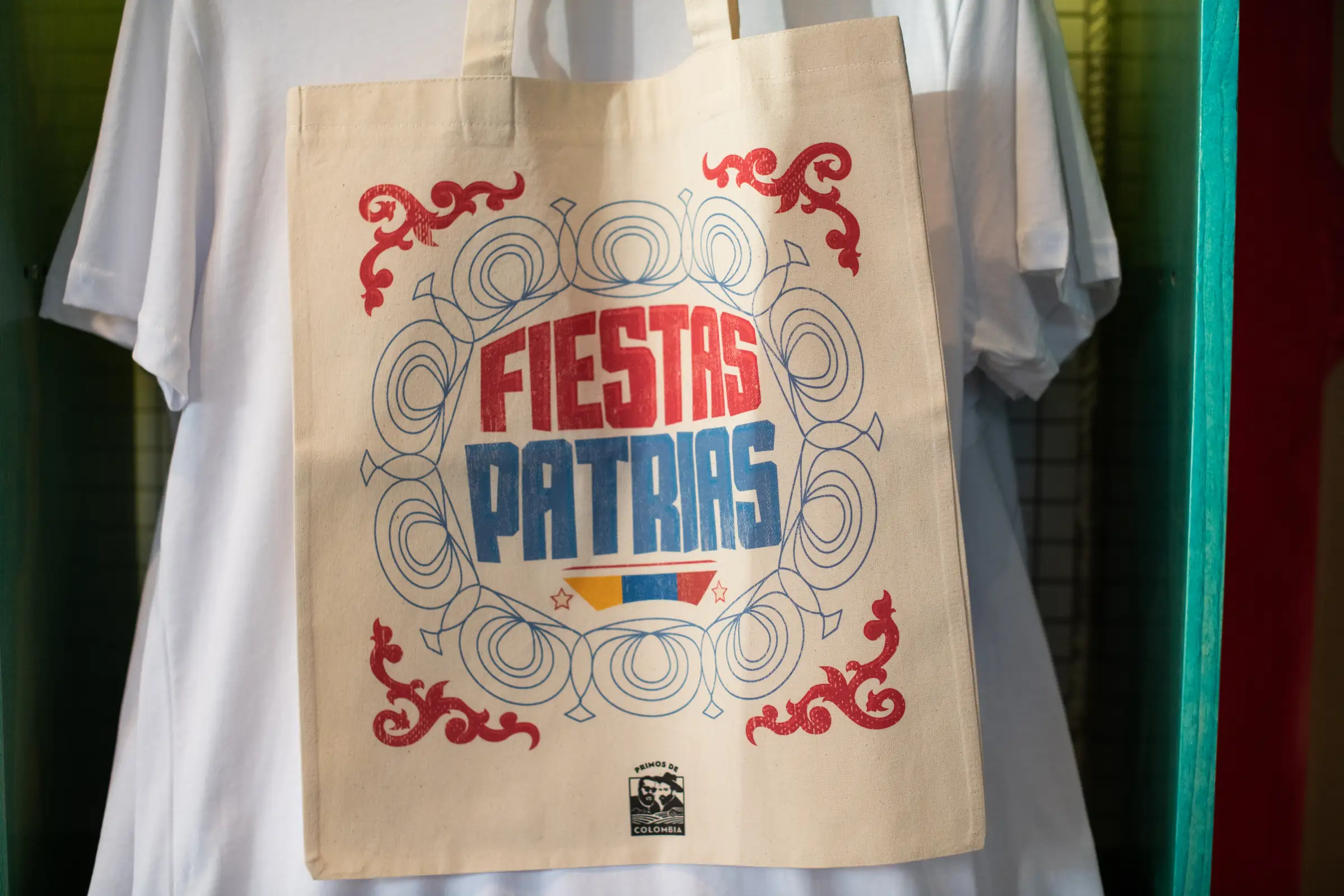 Screen printed tote bag photographed against a plain t-shirt