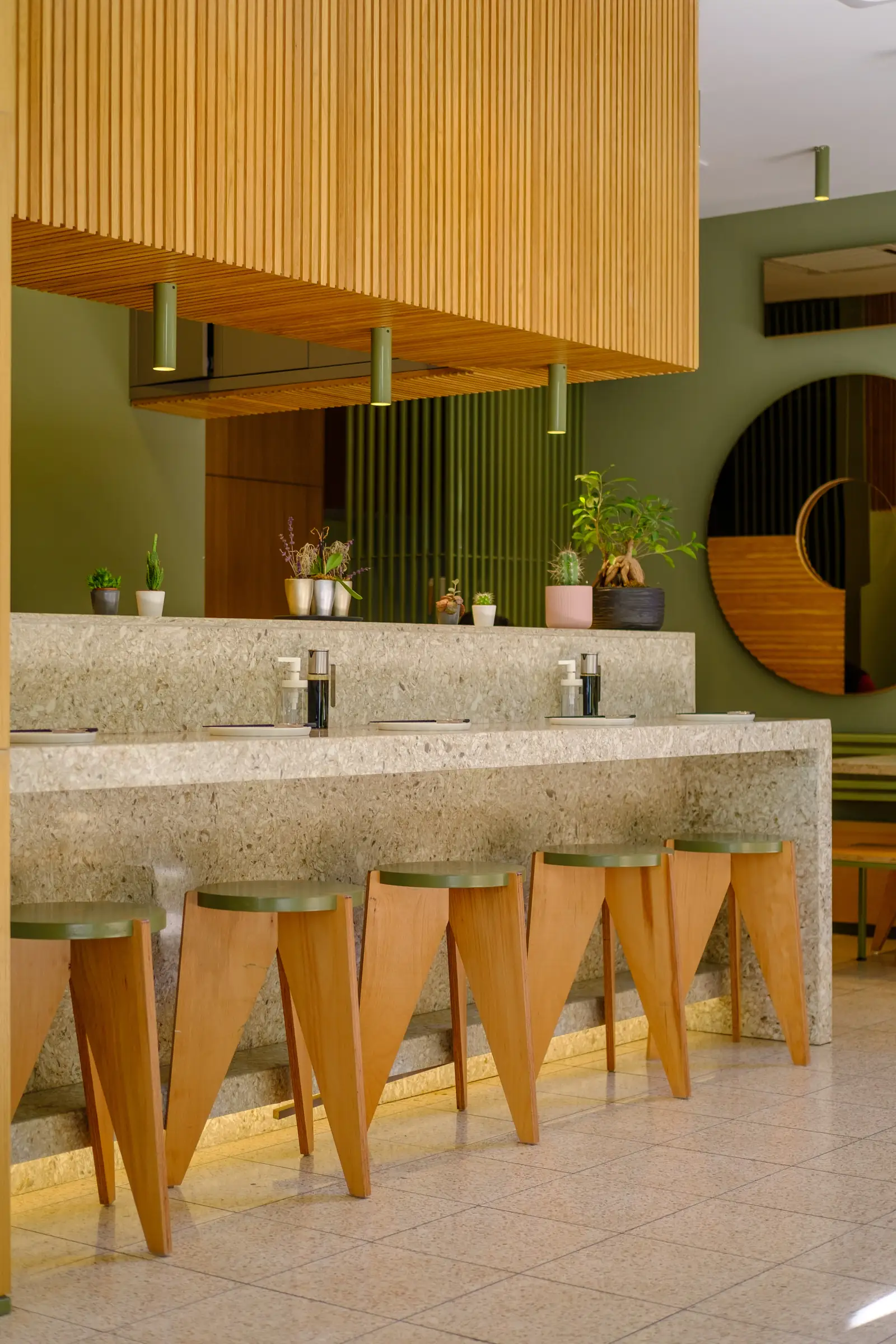 Terrazzo bar counter with wooden stools in a restaurant