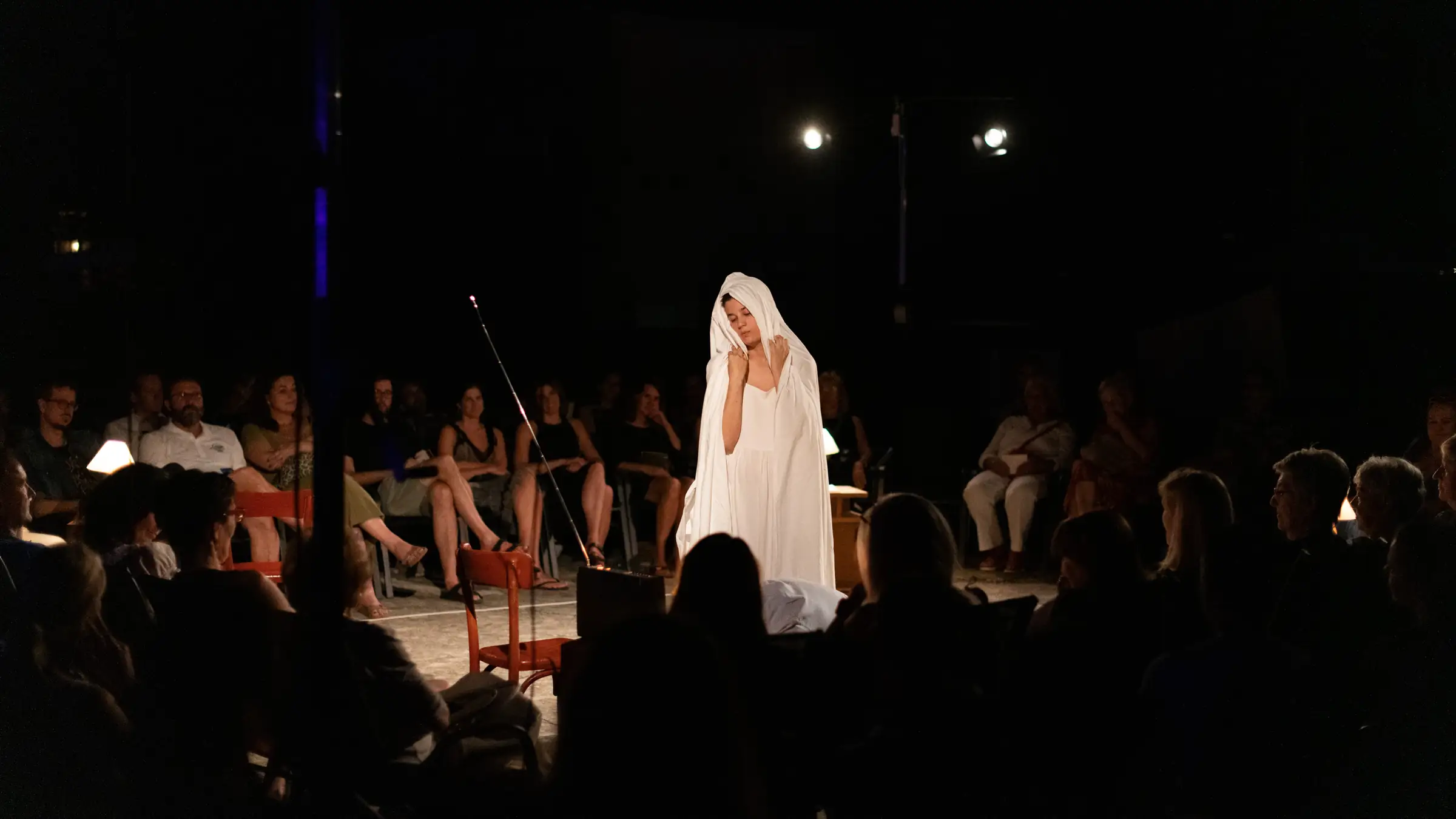 Actor alone under a spotlight during an open air performance
